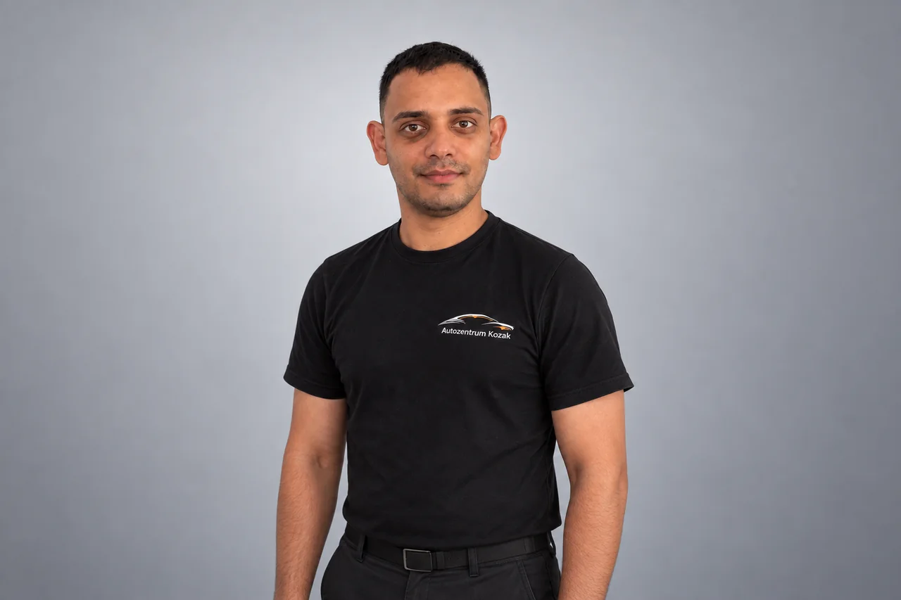 Mitarbeiterin oder Mitarbeiter des Autozentrums Kozak im schwarzen Firmenshirt
